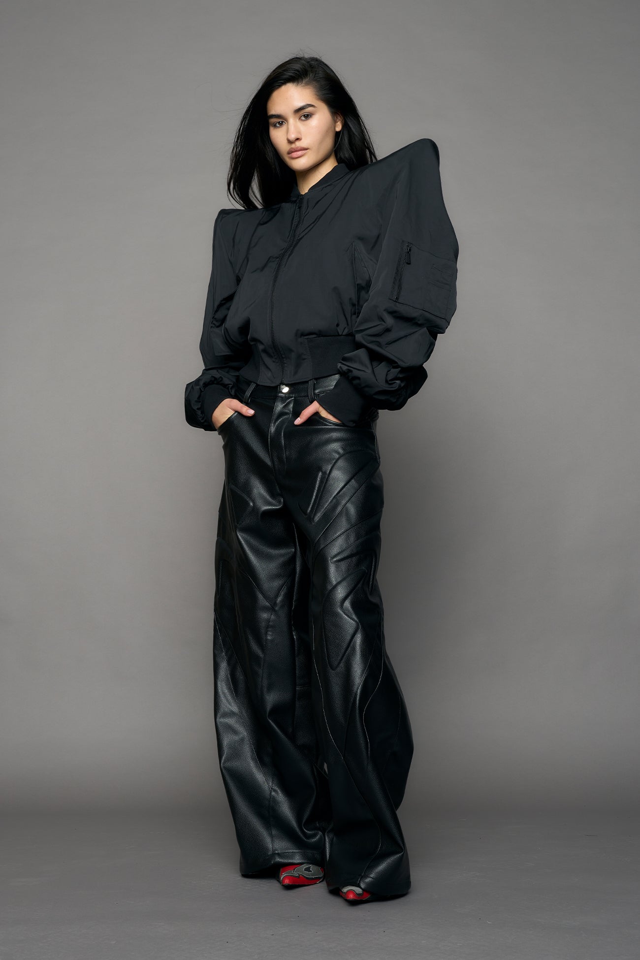 model wearing black bomber jacket with sharp shoulder design