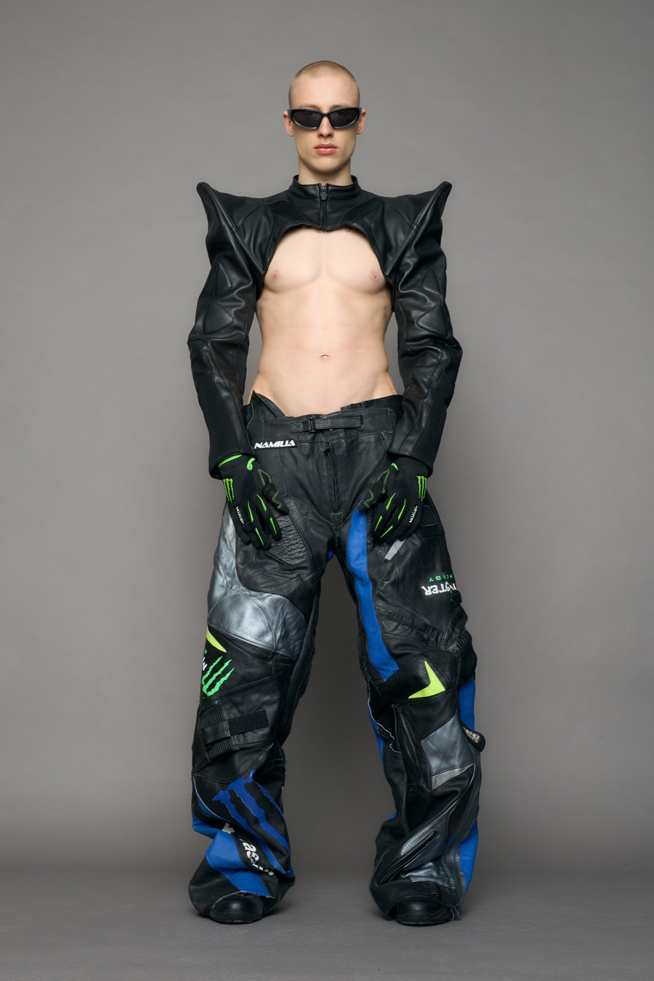 Model wearing a black leather choker jacket with cut-out design