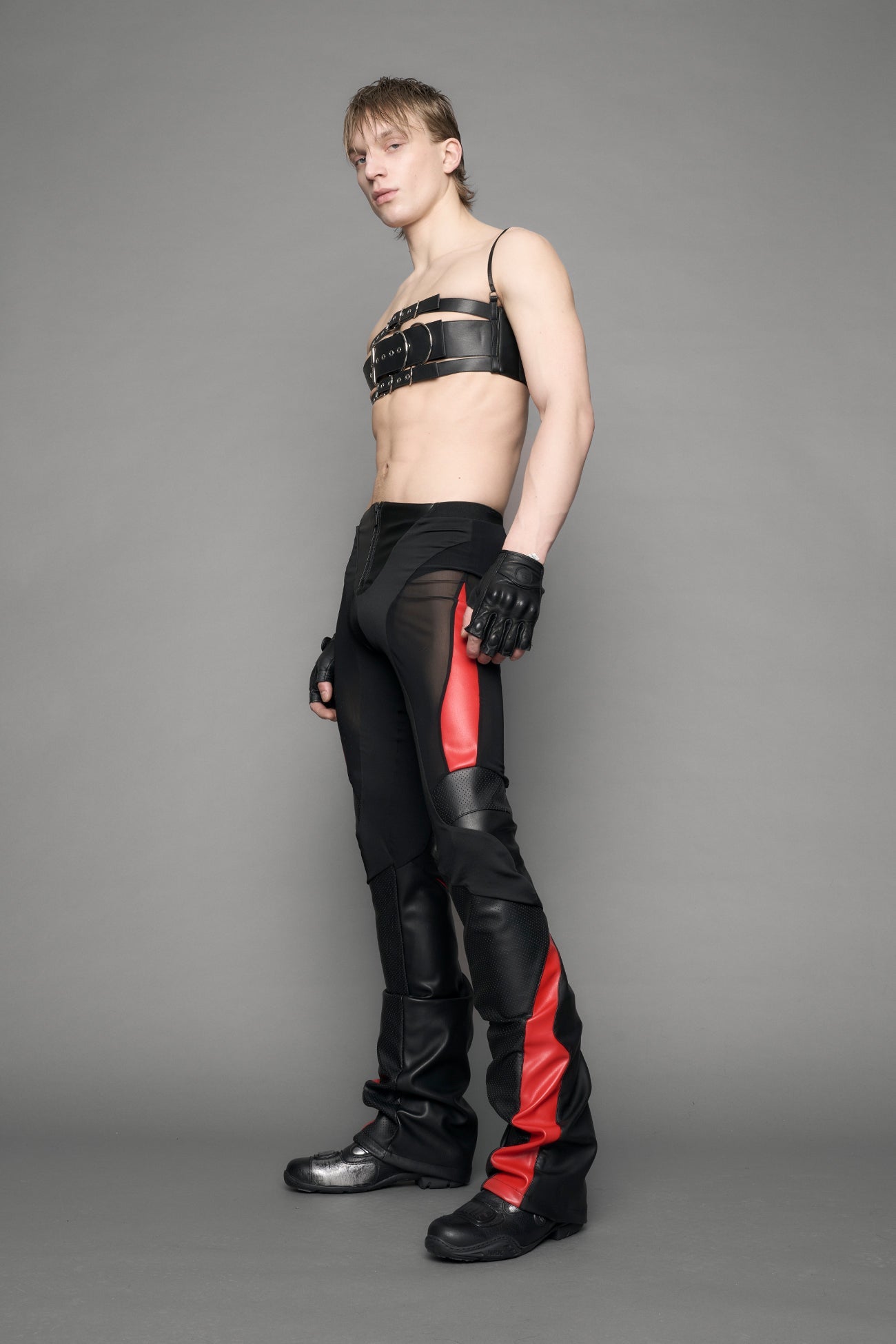 model wearing black red moto mesh pants