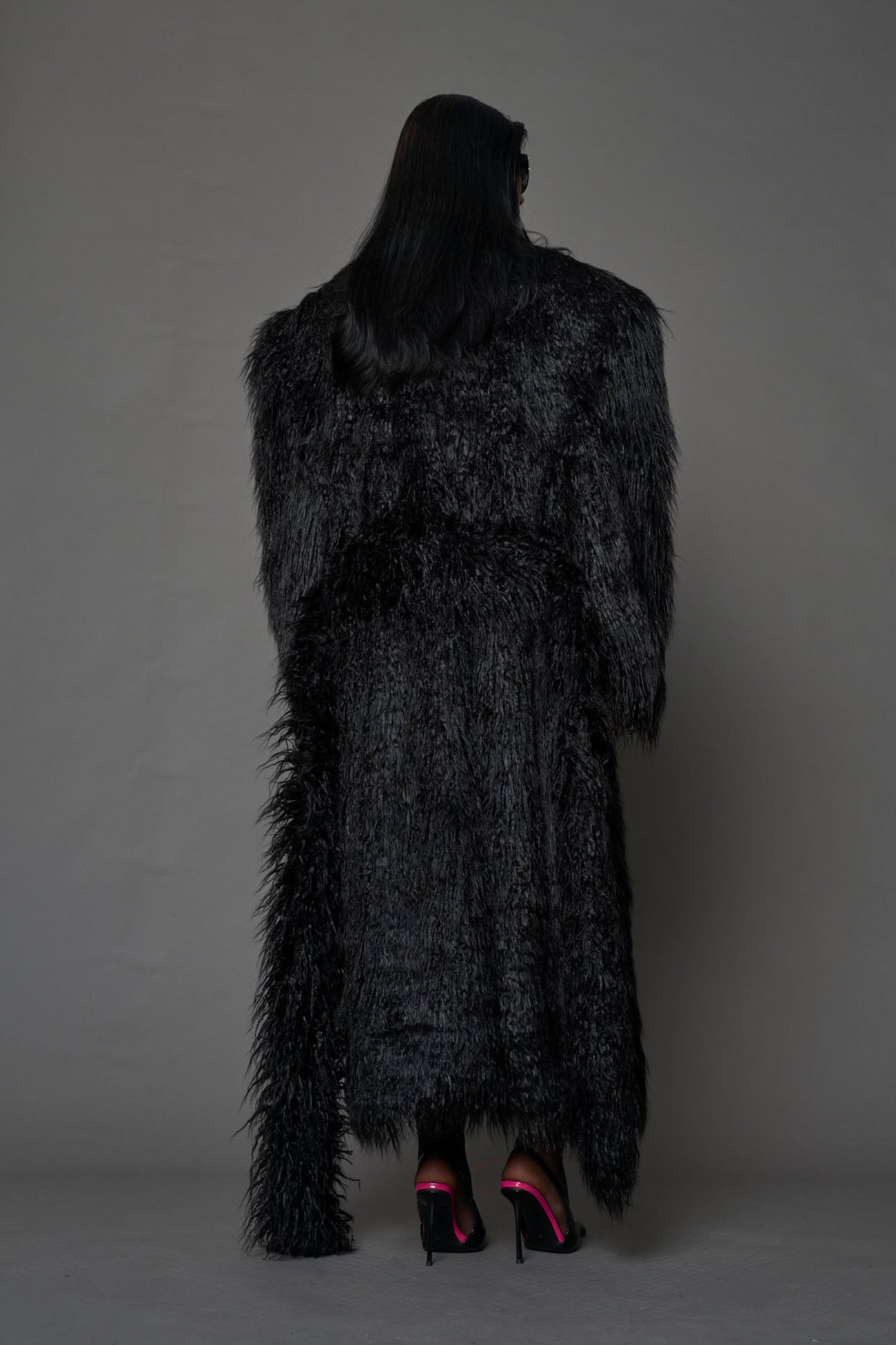 black faux fur coat with shoulder pads and belt