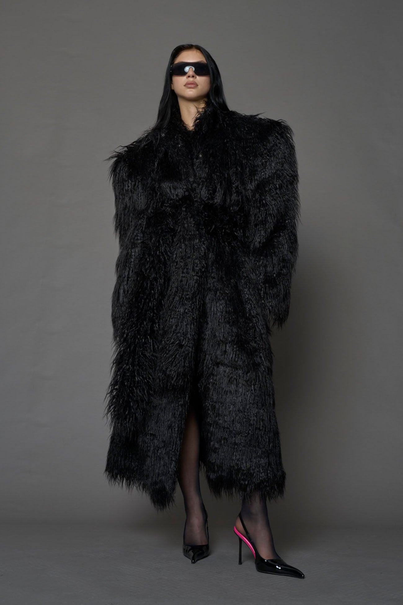 black faux fur coat with shoulder pads and belt