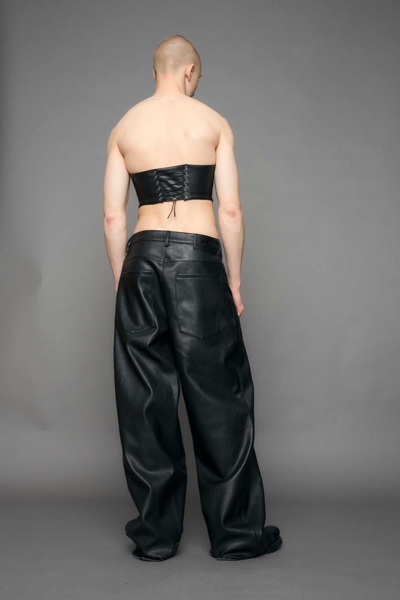 model wearing black pu leahter corset with handbag design 