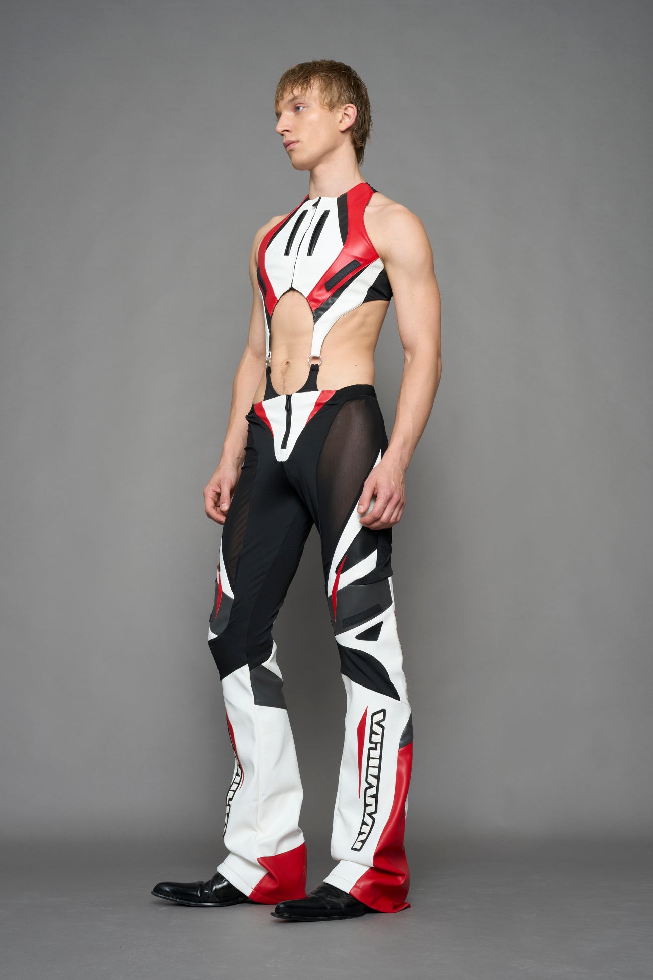 model wearing red black white moto inspired mesh pants with logo on the leg
