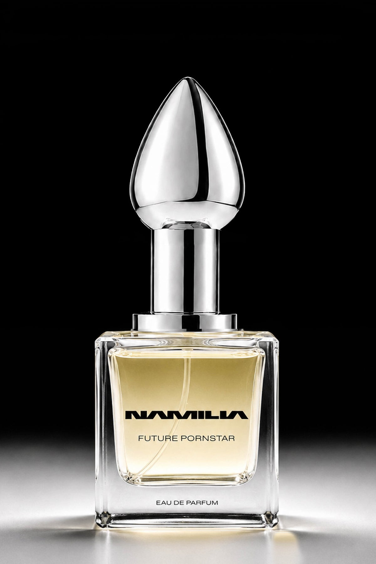 A bottle of Namila  Eau de Parfum with a large reflective plug-shaped cap