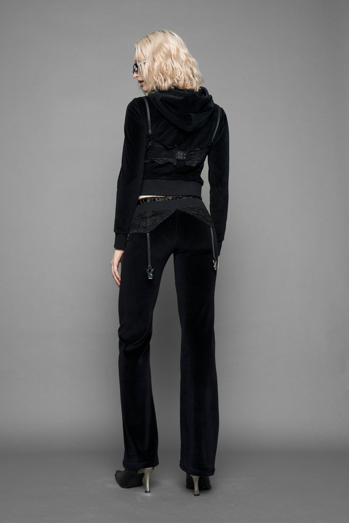 model is wearing a black velvet cropped zip-up hoodie with a black lace bralette and a Playboy branded key formed Zipper Pull 
