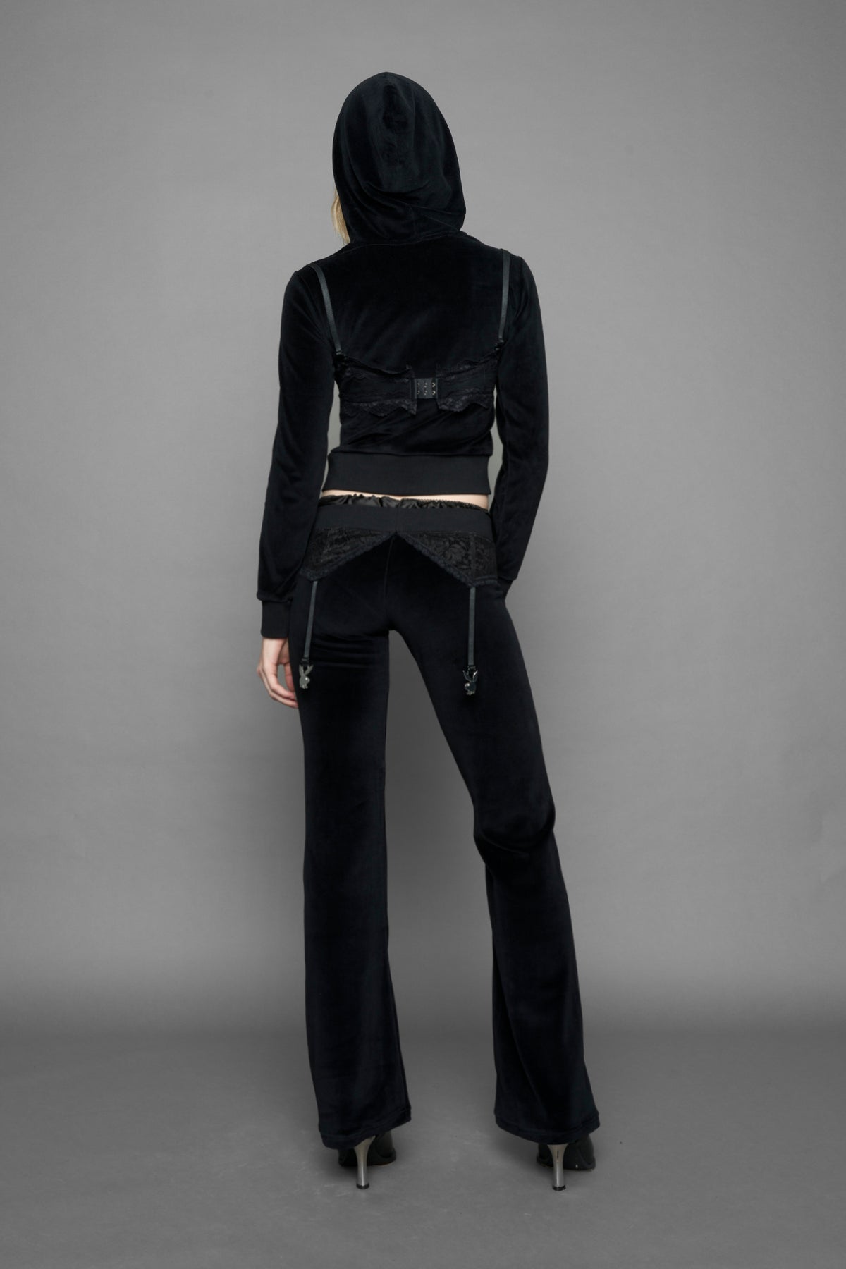 model is wearing a black velvet cropped zip-up hoodie with a black lace bralette and a Playboy branded key formed Zipper Pull 