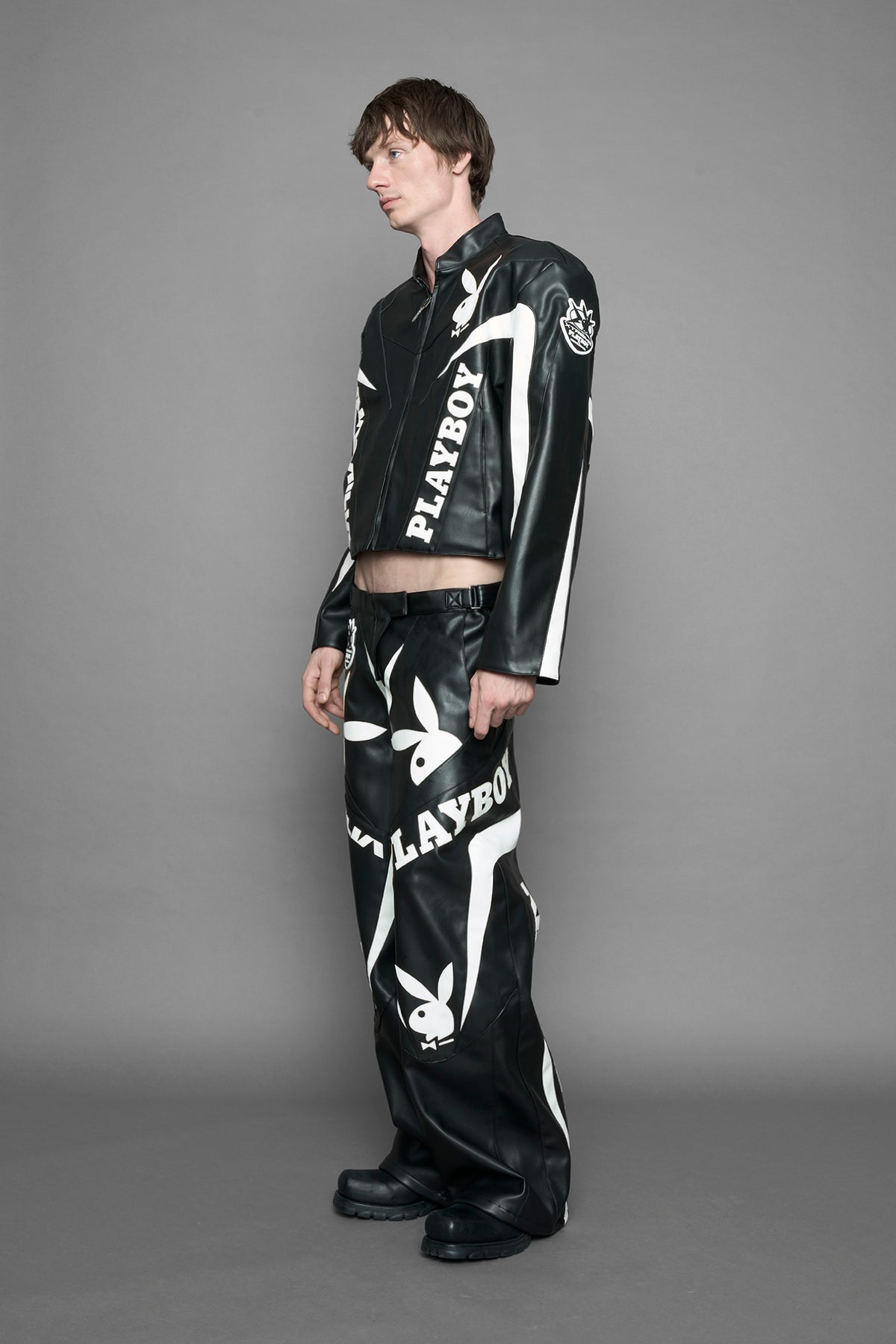 model is wearing black PU Leather pants with bold white Playboy bunny logos and white 'Namilia' Embroidery.